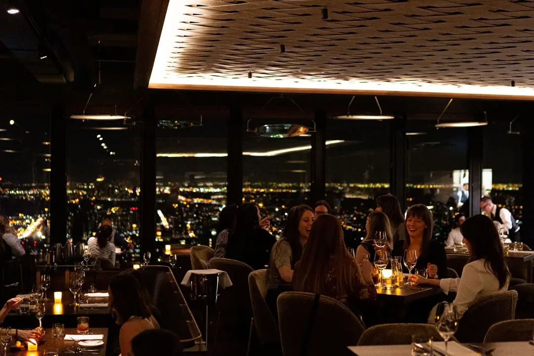Canoe’s dining room at night above the lights of downtown Toronto
