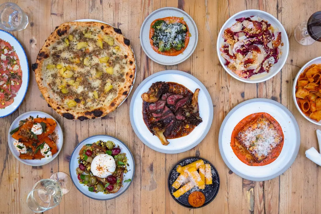 Pizza, pasta and shared plates spread across a table at Gusto 101