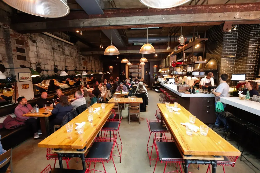 The long, busy dining room at Gusto 101, a converted garage with an open kitchen