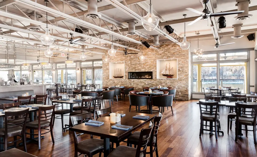 Snug Harbour’s bright dining room with a stone fireplace