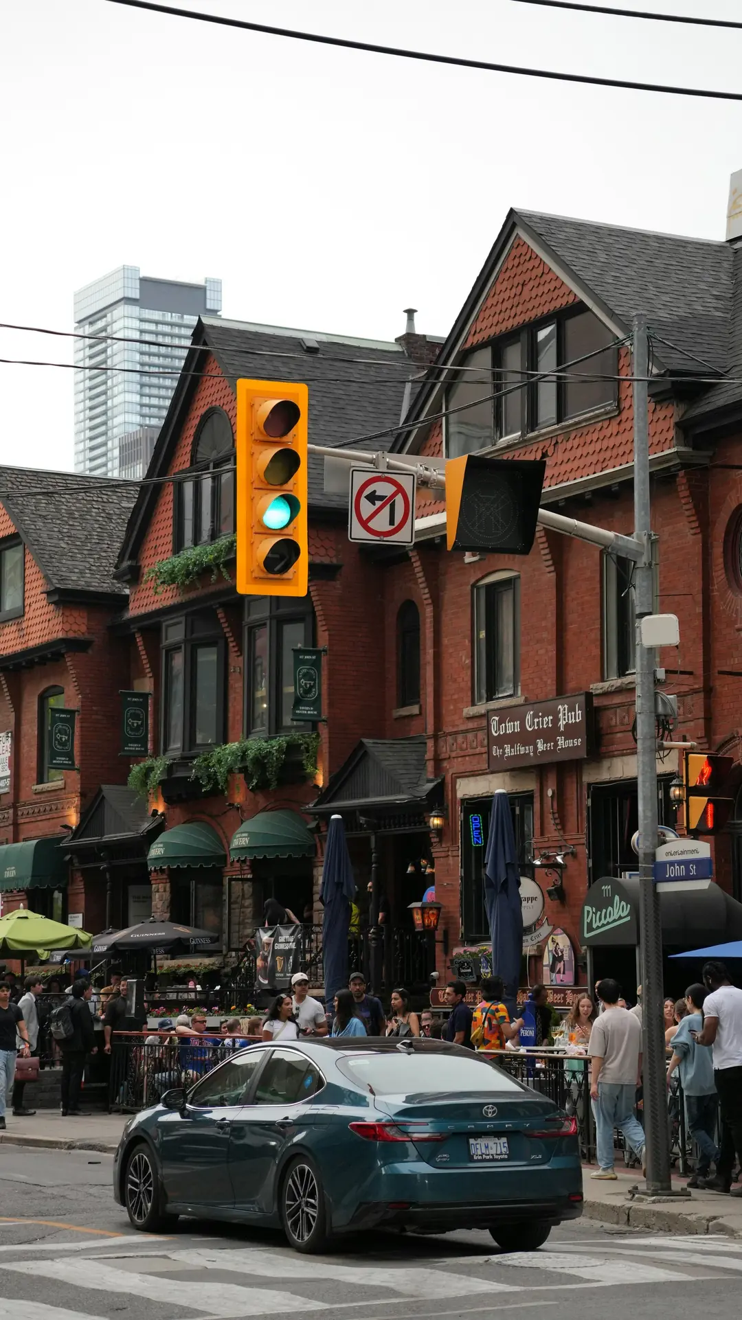 Brick buildings and outdoor dining on John Street in downtown Toronto on a summer evening